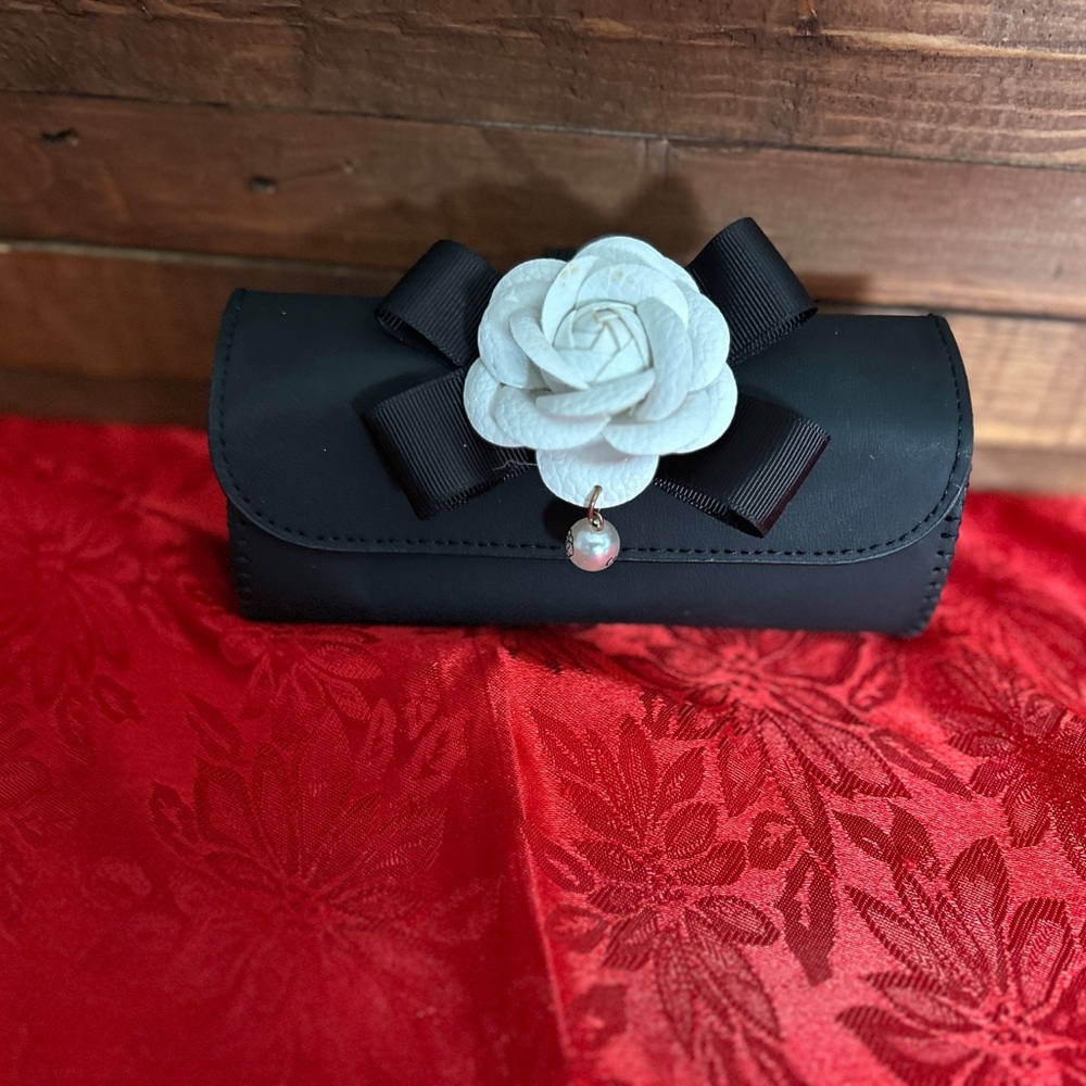 Elegant Black Visor Sunglasses Holder with White Floral Accent